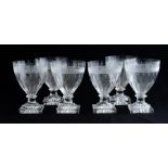 A set of six 19th Century clear glass pedestal wines, etched and broad fluted conical bowls,