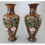 A pair of Royal Doulton vases, c. 1900-20. Both decorated with flowers and leaves on a mottled brown