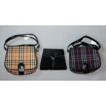As new!! Two Burberry shoulder bags; one navy and red check with leather clasp, shoulder straps; a