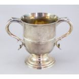 A George II silver loving cup, double C scroll handles with heart terminals, collet foot,
