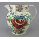 An early nineteenth century pearlware jug, c.1820. It is boldly painted in enamels with flowers