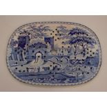 An early nineteenth century Castle pattern large blue and white transfer printed drainer, c.1825. It
