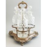 A 19th Century Sheffield plated trefoil decanter stand, of scroll design with three cylinder clear