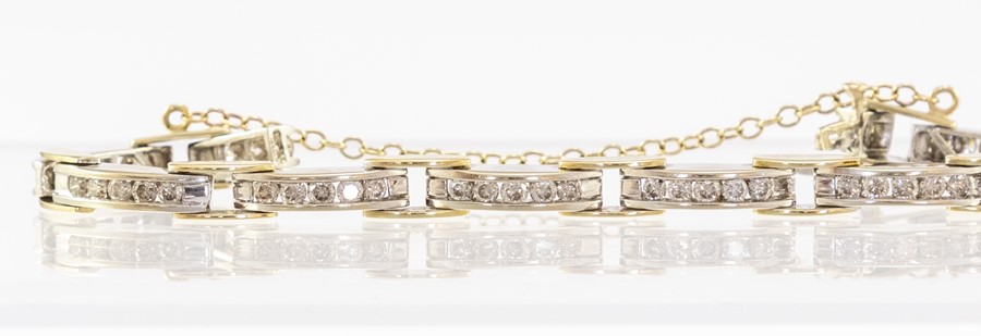 A two colour 18ct gold diamond bracelet of twelve rectangular links, each channel set five brilliant - Image 2 of 3