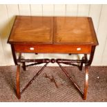 An Edwardian mahogany child's writing desk, circa 1905, two panel lids opening to an adjustable