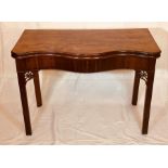 A George III mahogany serpentine fold over card table, circa 1770, in the manner of Thomas