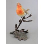 An Albany Fine China Co. ceramic bird study incorporating metal. Modelled as a Robin. Factory mark