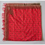 A woven red silk Victorian shawl with a decorated green paisley wide hemline round the circumference