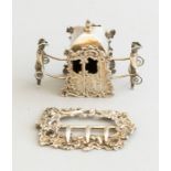 A Dutch white metal miniature or toy model of a sedan chair, appears unmarked, and a silver buckle
