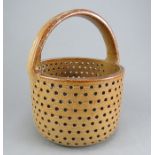 An early nineteenth century salt glazed stoneware large basket, c. 1800-10. It has a wide strap