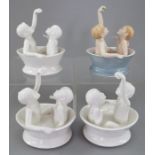 A group of four Albany Fine China Co. children in a bath model. One naturalistically decorated,