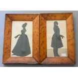 A pair of 19th Century silhouette profile portraits of a gentleman and lady standing, on card, 24 by