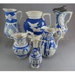 A group of early nineteenth century blue and white stoneware relief moulded jugs, c.1830-60. To
