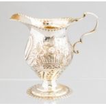 A late Victorian silver milk jug, double C scroll handle, repousse scrollwork decoration, maker