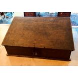 An early 18th century slope shape oak bible box, Circa 1710, slope top lid with cast metal lock on a