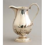 A George VI silver milk jug, scroll handle, thistle leaf frieze, baluster body, maker Edward & Sons,