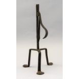 An 18th Century wrought iron rush table light holder, tripod base with pad feet, height 27cm