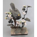 An Albany Fine China Co. ceramic bird study incorporating metal. Modelled as a Blackbird sitting