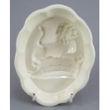 A fine late eighteenth century Wedgwood creamware jelly mould, c. 1790. It depicts a armorial