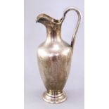 A mid Victorian silver claret jug/wine ewer, of classical form with military presentation