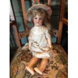 An Armand Marseille bisque head girl doll, sleeping eyes, open mouth, nape stamped 390/8,
