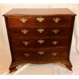 A George III mahogany serpentine chest of drawers, circa 1790, in the manner of Thomas