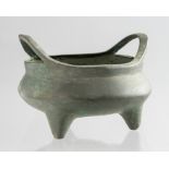 A small Chinese bronze twin handled censer, tripod feet, cast sixteen character Xuande mark but