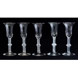 A set of five 18th Century style clear glass wines, 20th Century century, bell bowls, single knop