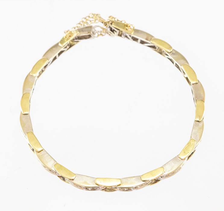 A two colour 18ct gold diamond bracelet of twelve rectangular links, each channel set five brilliant - Image 3 of 3
