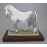 An Albany Fine China Co. model of a dappled grey horse on wooden base. Factory marks to base. 23