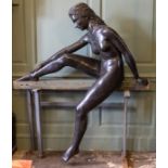 A contemporary garden bronze statue of a female nude dipping her foot in water, height approximately