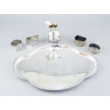 An Edwardian serpentine silver dressing table tray, Birmingham 1910, a silver bombe cream jug and