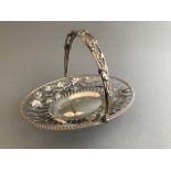A late Victorian silver wirework oval basket with fruiting vine and wheatear swing handle, Sheffield