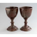 A pair of 19th Century carved serpentine goblets, single knop stems, stepped circular bases,