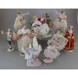 A group of Continental porcelain figures and figure groups, most with lace-work. Also, a swan