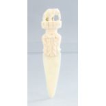 An antique ivory letter knife, surmounted with a carved elephant, height 14cm