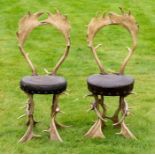 A pair of 19th Century antler hall chairs, the backs and legs formed from antlers, embossed
