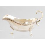 An Elizabeth II silver sauce boat, gadroon border, hoof feet, maker Barker Ellis, Birmingham 1968,