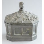 An early 19th Century slave trade tobacco box, the cover finial formed as a negro head surrounded by
