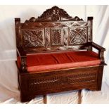 A Jacobean revival 19th century oak settle, circa 1860, serpentine shape carved top, three moulded