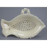 A fine late eighteenth century creamware footed drainer, c. 1790. It is of fish-shape and stand upon