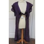 An Aubergine/Purple robe which would have been worn over another garment. The robe is heavily