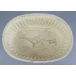 An early nineteenth century creamware jelly mould, c. 1810. It depicts and plough to the centre