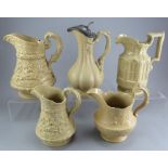 A group of early nineteenth century yellow stoneware relief moulded jugs, c.1830-50. To include: two