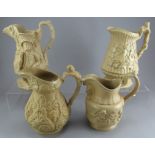 A group of early nineteenth century yellow stoneware relief moulded jugs, c.1830-50. To include: a