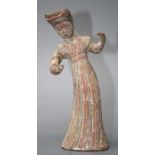 An old Chinese terracotta tomb figure of a dancing figure with incised and  remains of poly-