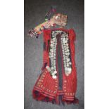 A 20th century probably Turkmen  woman's tribal costume with hat adorned with tassels, coins and