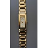 lady's 9ct gold Accurist wristwatch, the rectangular champagne dial inset to integral open brick