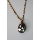 A Russian silver gilt and cloisonné enamel egg pendant, decorated with polychromatic scrolls,