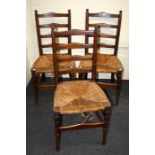 Three early 20th century Arts and Crafts style walnut ladder back side chairs with woven rush seats.